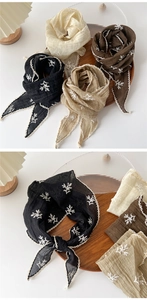 Detailed view of four cotton linen floral embroidered scarfs with elegant lace trim