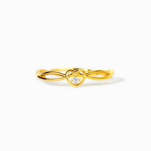 Gold heart ring with a central white diamond and interlaced band on white background
