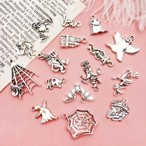 Detailed flat lay of silver Halloween charms including skulls, bats, and ghosts for DIY jewelry
