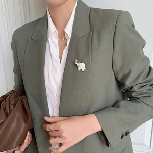 Cute cartoon elephant brooch with sparkling rhinestones on green suit lapel