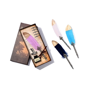 Vintage quill pen set with purple feather inkwell base and five metal nibs in a gift box