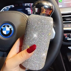 Close-up of luxury silver rhinestone insulated travel mug with sparkling crystals