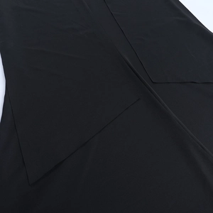 Detail of the black matte fabric texture and tailoring of this slim party evening dress