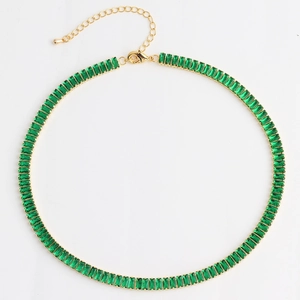 Tennis style golden necklace with emerald green rectangular cut crystals on white background