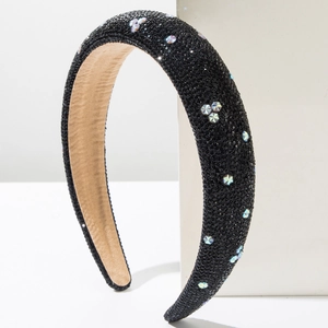 Detail view of padded black headband featuring sparkling star rhinestones on white blocks