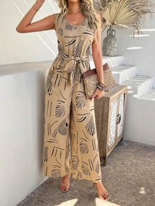 Detail of khaki sleeveless jumpsuit with black abstract print and waist tie design
