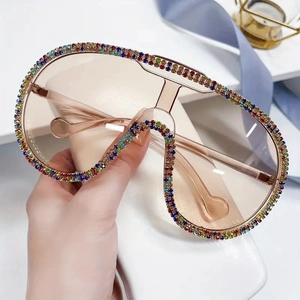 Oversized shield sunglasses with champagne lenses and colorful rhinestone embellishments
