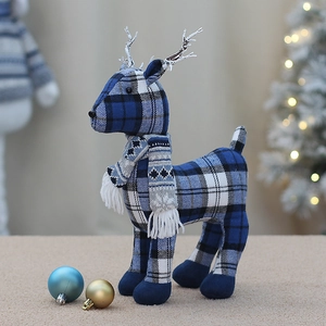 Blue plaid fabric Christmas reindeer figurine in a warm festive holiday room setting