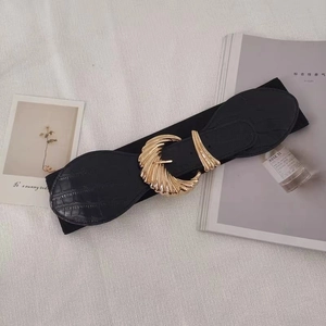 Classic black elastic waist belt with gold shell buckle and crocodile texture details