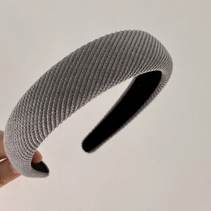 Close-up of grey ribbed knit headband showing thick texture and black inner lining