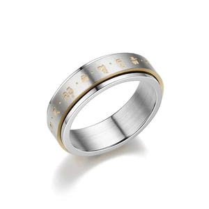 Macro shot of two-tone rotating anxiety ring with brushed silver and gold finish