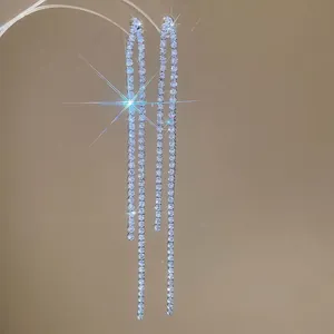 Sparkling silver drop earrings with long zircon tassels and elegant sparkling starburst effect