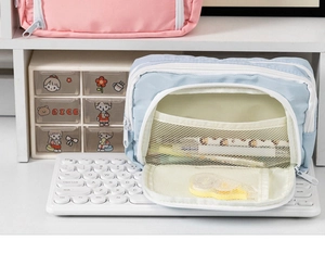 Detail view of light blue pencil case with interior mesh pocket and elastic straps