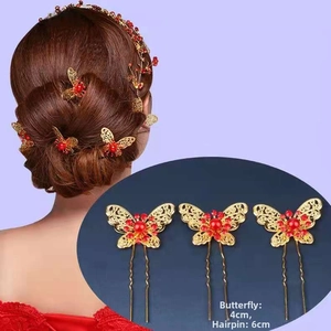 Detailed view of gold butterfly hair pins with red beads and precise size measurements