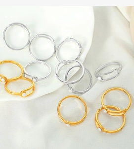 Detailed top view of gold and silver plated titanium rings with faux pearl accents