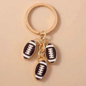 Fashion gold keychain with three brown and white metal American football pendants
