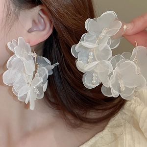 Elegant large cream lace flower earrings with crystal beads and gold hooks worn by a model