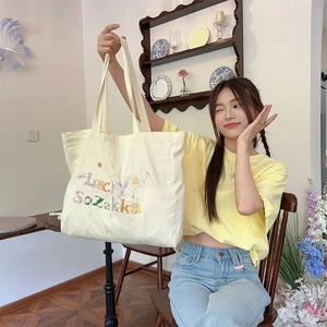 Détail d'un sac cabas en toile crème avec broderie colorée Lucky Sozakka et motifs