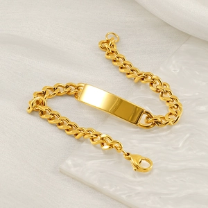Detail of a gold stainless steel Cuban link bracelet with a polished engravable ID plate