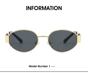 Detail view of oval sunglasses with gold metal frame and dark grey lenses for a retro look