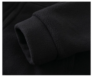 Close-up of premium black polar fleece fabric texture and high-density stitching details