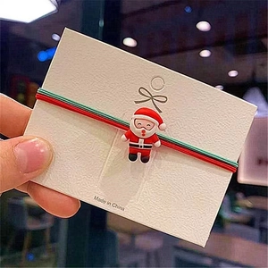 Festive Christmas hair tie with Santa Claus charm and durable red green elastic rope