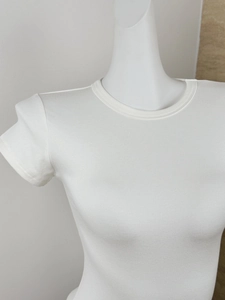 Detail of white round neck slim fit T-shirt showing fine ribbed fabric texture