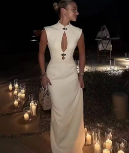 Detail of sleeveless ivory slim dress with teardrop cutout and metal buttons