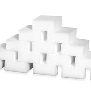 Bulk white nano cleaning sponges stacked in a pyramid shape on white background