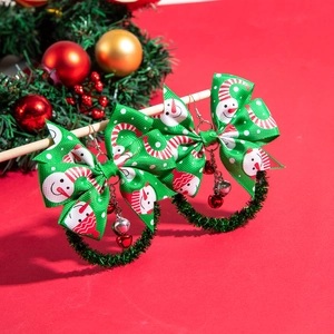 Detail of Christmas wreath earrings with snowman bows and colorful festive bells
