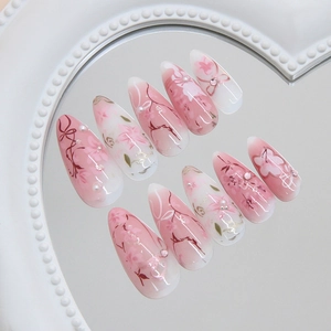 Pink and white gradient almond press-on nails with pearl, floral and rhinestone accents