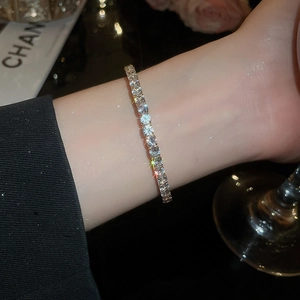 Macro shot of silver tennis bracelet with brilliant-cut stones and claw setting