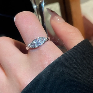 Close-up of sparkling zircon flower ring with marquise cut stones on a female finger