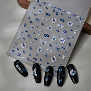 Macro view of 5D blue evil eye nail stickers with embossed textures and patterns