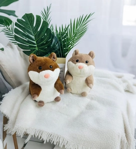 Close-up of two cute guinea pig plush toys sitting on a soft white fringed blanket