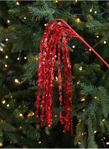 Detail of red glittered branch spray with sequins for Christmas tree decoration