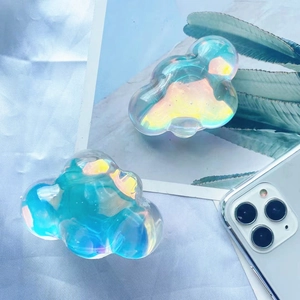 Detail of blue and silver iridescent cloud-shaped phone grip sockets on a smartphone