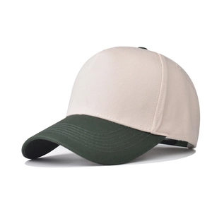 Detail view of cotton baseball cap with cream crown and dark green brim panels