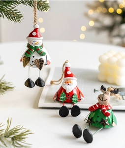 Detail view of resin Santa, snowman and elk hanging ornaments with dangling iron legs
