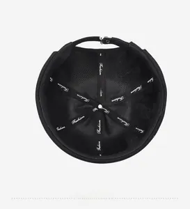 Detail view of the black docker cap interior with Fashion branded tape and reinforced seams
