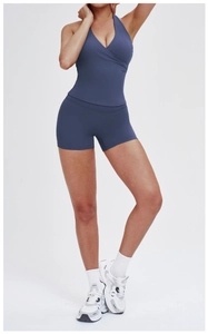 Detail of V-neck halter yoga top and high-waist biker shorts in matte dark blue-gray