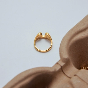 Detail of 18K gold-plated stainless steel U-shaped ring with minimalist groove design