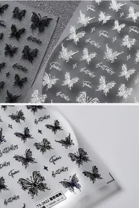 Detail shot of self-adhesive butterfly nail art stickers in black and white styles