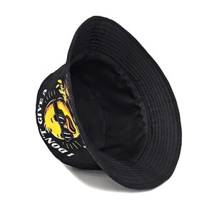 Close-up of black canvas bucket hat with cool yellow duck and letter printing