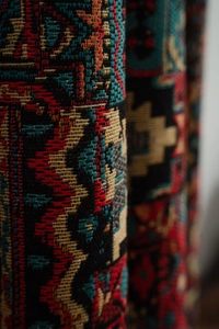 Close-up of ethnic geometric jacquard fabric with textured weave and vibrant patterns