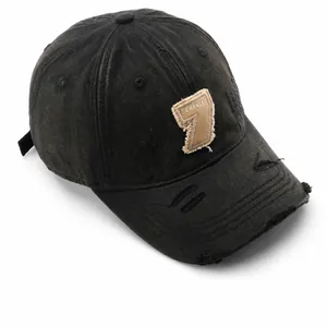 Close-up of distressed vintage black baseball cap featuring Change 7 frayed patch detail