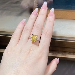 Macro shot of S925 silver ring featuring a yellow radiant cut zircon and side diamonds