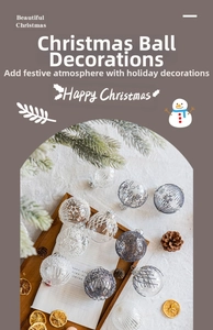Close-up of clear Christmas ornaments with white snowflake patterns on a wooden tray