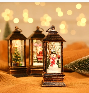 Close-up of vintage bronze Christmas lanterns with snowman and Santa interior scenes