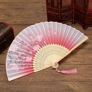 Detailed view of silk folding fan with cherry blossoms, butterflies and pink tassel